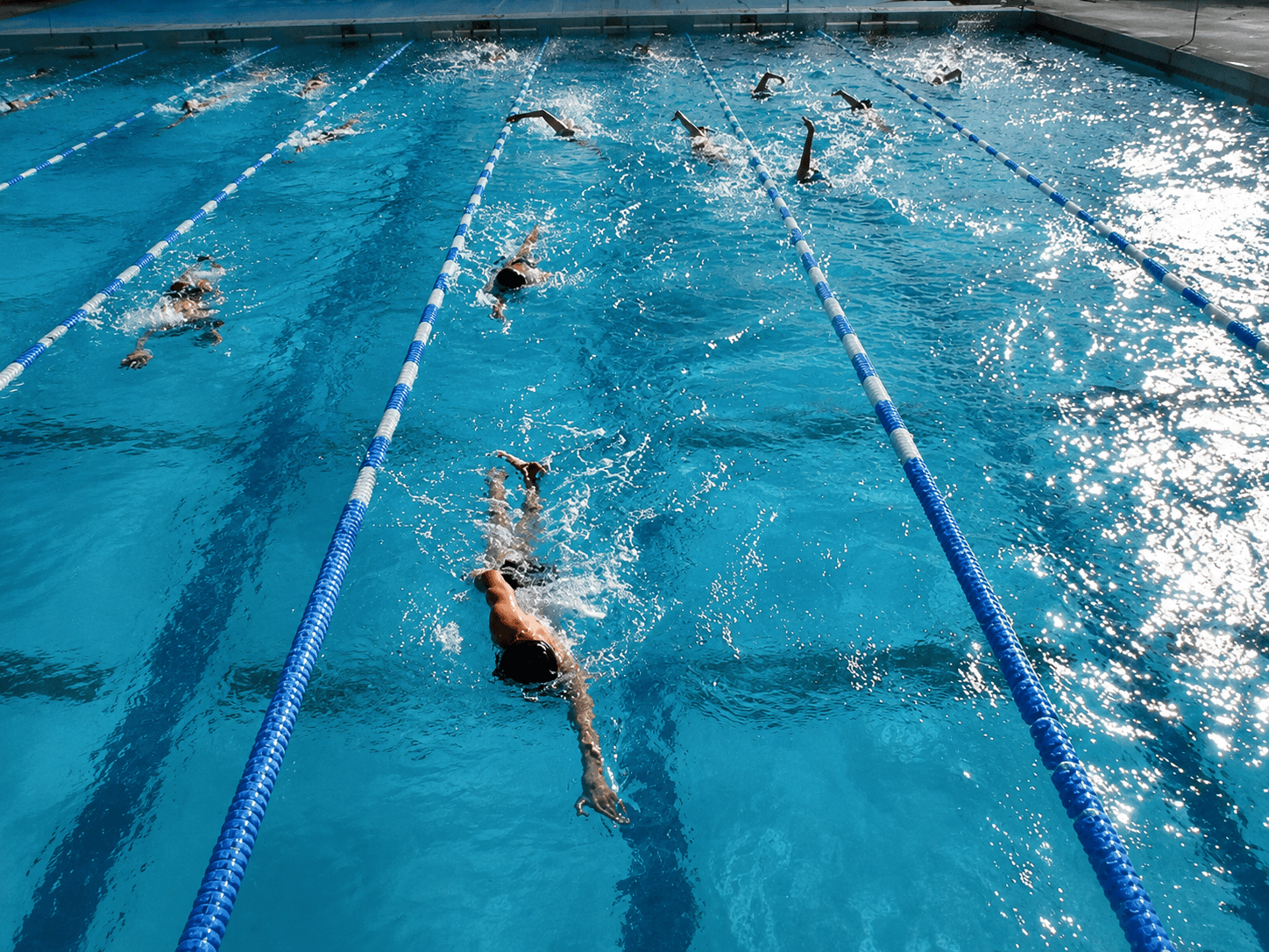 Swimmers in pool lanes from above for the CSS Pace Calculator
